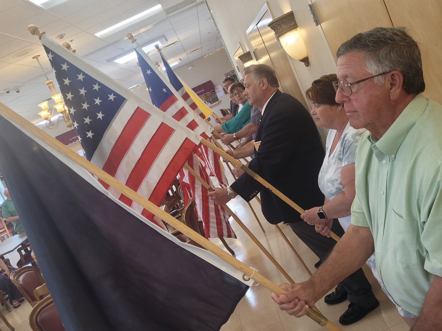 BANNERS UNITED: Members of Warwick’s Tri-City Elks Lodge held flags from throughout the American experience. From the original “Stars & Stripes” to an “MIA/POW” flag, patriotism was on full display during the Flag Day ceremony held at the Johnston Senior Center.  (Sun Rise photos by Rory Schuler)